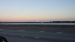 Mount Ranier at Sunset Much of the time the mountain is hidden in clouds, but at moments such as this, from the floating bridge across Lake Union, its appearance is startling.  